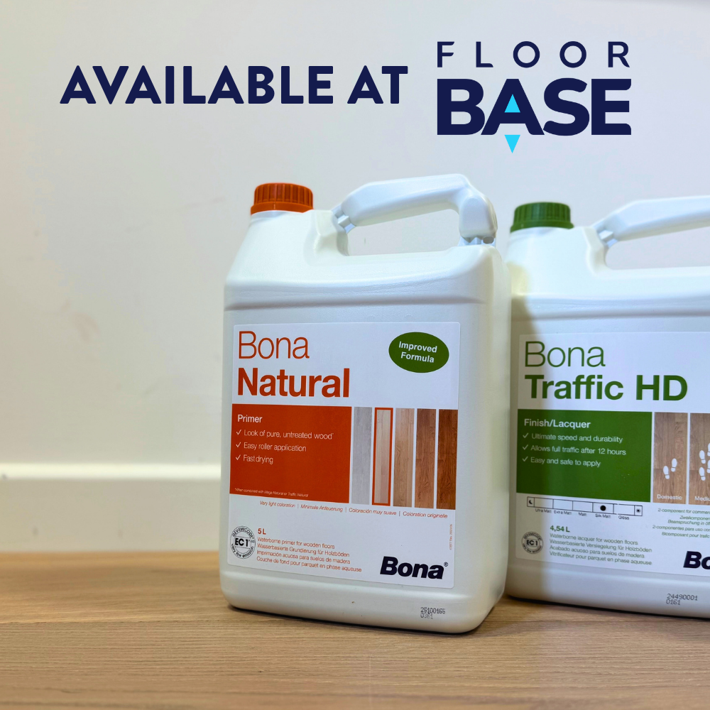 Close up photograph of Bona Natural Primer and Bona Traffic HD Lacquer stood side by side on a wood floor against a white wall background